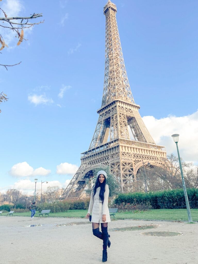 parisian outfit long sleeve tweed dress in front of the eiffel tower in paris france